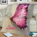 Artistic pink butterfly blanket draped over a sofa in a reading area