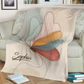 Close lifestyle view of a colorful butterfly throw blanket with delicate line-art details