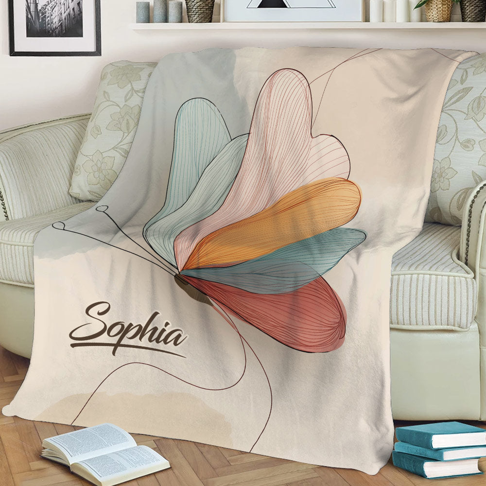 Close lifestyle view of a colorful butterfly throw blanket with delicate line-art details