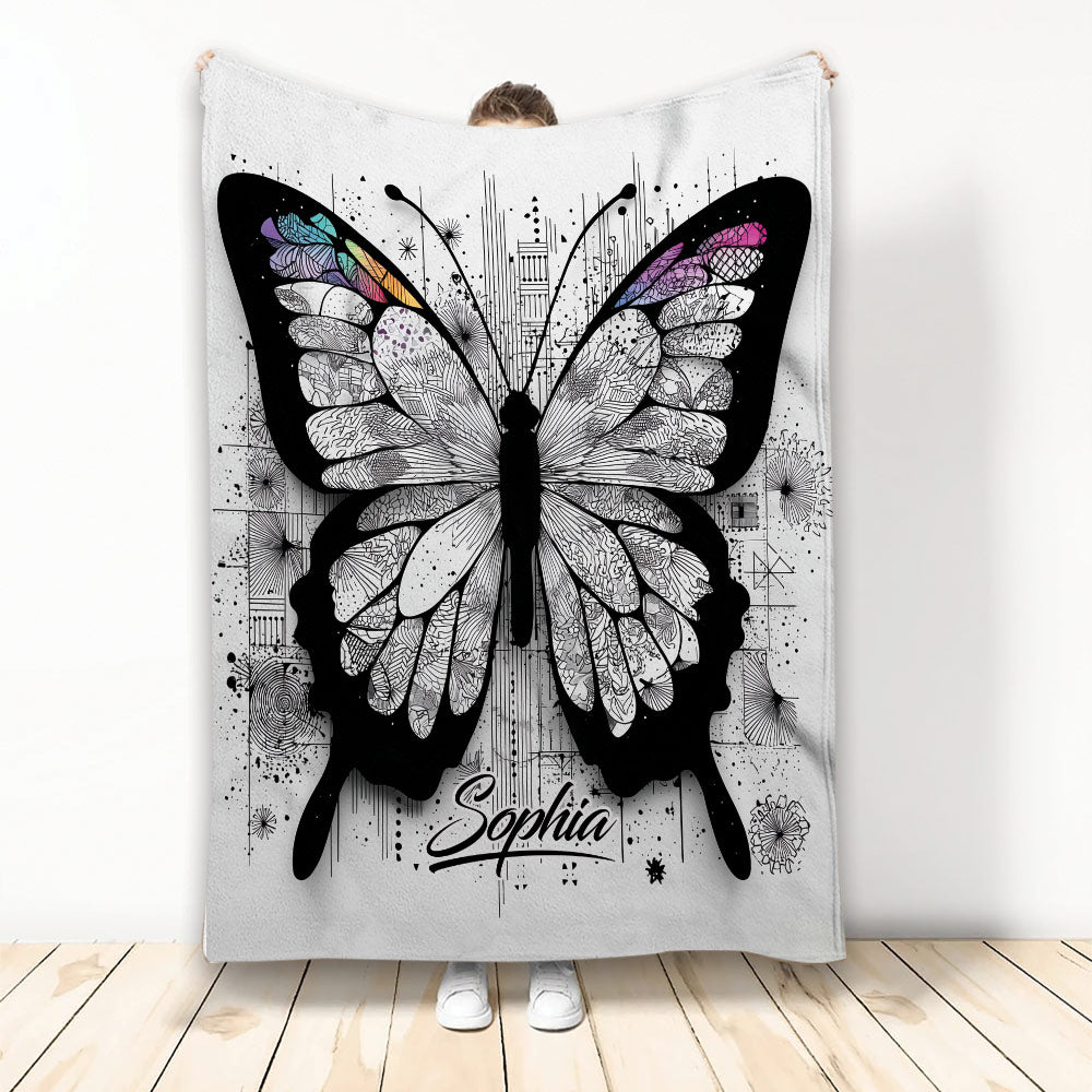 Butterfly throw blanket with intricate black-and-white wings and colorful accents displayed in a bright room