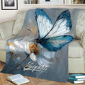 Close-up blue butterfly floral blanket styled across a sofa in a relaxing reading space