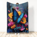 Blue butterfly blanket with vibrant orange, pink, and purple flowers in a colorful painterly design