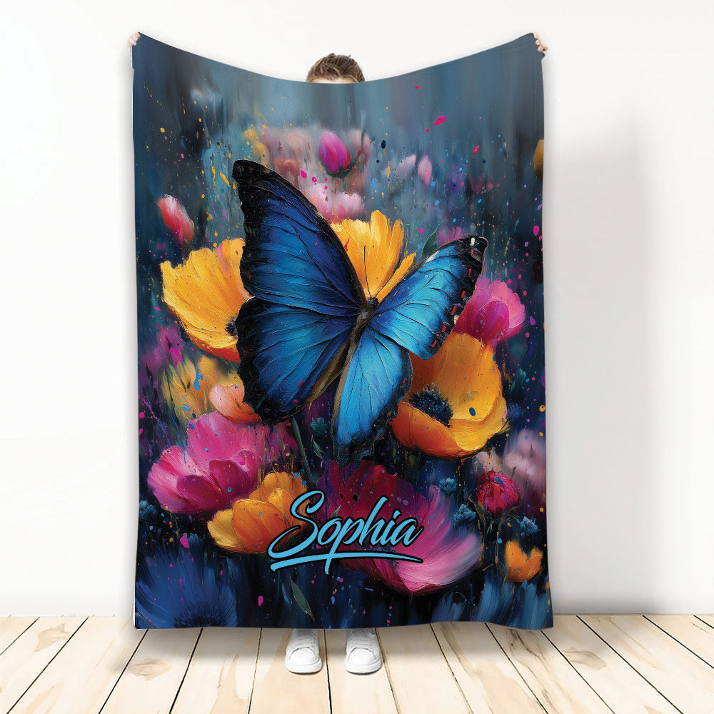 Blue butterfly blanket with vibrant orange, pink, and purple flowers in a colorful painterly design
