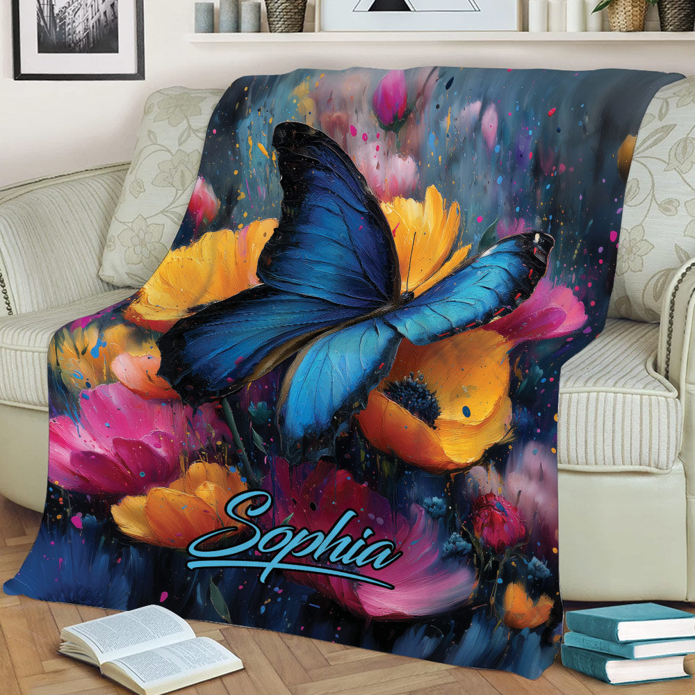 Blue butterfly blanket displayed on a sofa with bold painterly flowers and rich jewel tones