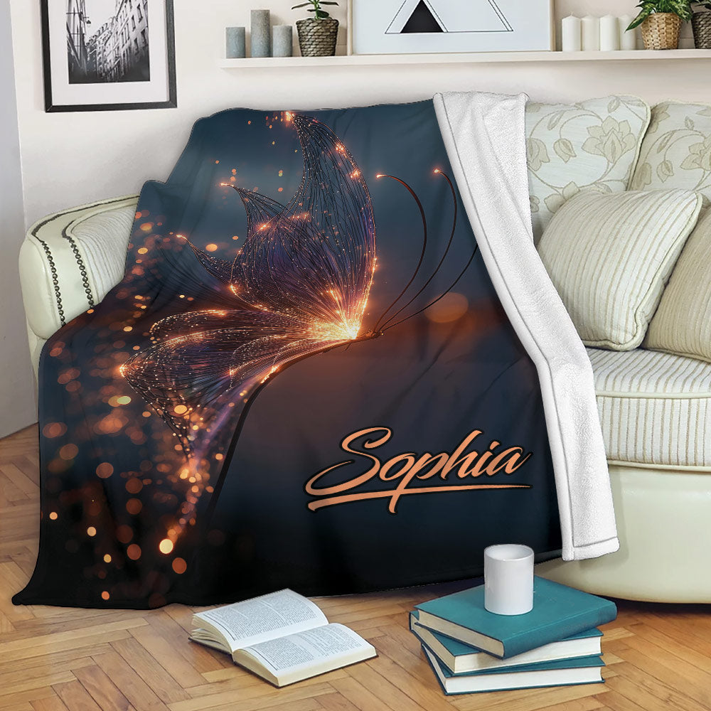 Glowing butterfly blanket draped over a sofa with sparkling orange light details and dark blue artwork