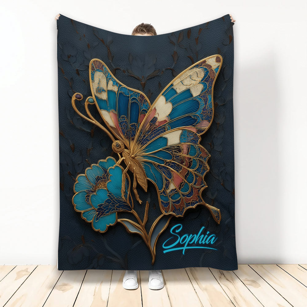 Decorative butterfly blanket with ornate blue and gold wings on a dark floral background