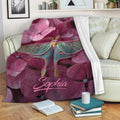 Custom butterfly throw blanket with vivid floral artwork styled on a living room sofa
