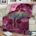 Colorful butterfly and pink flower throw blanket draped across a cozy armchair