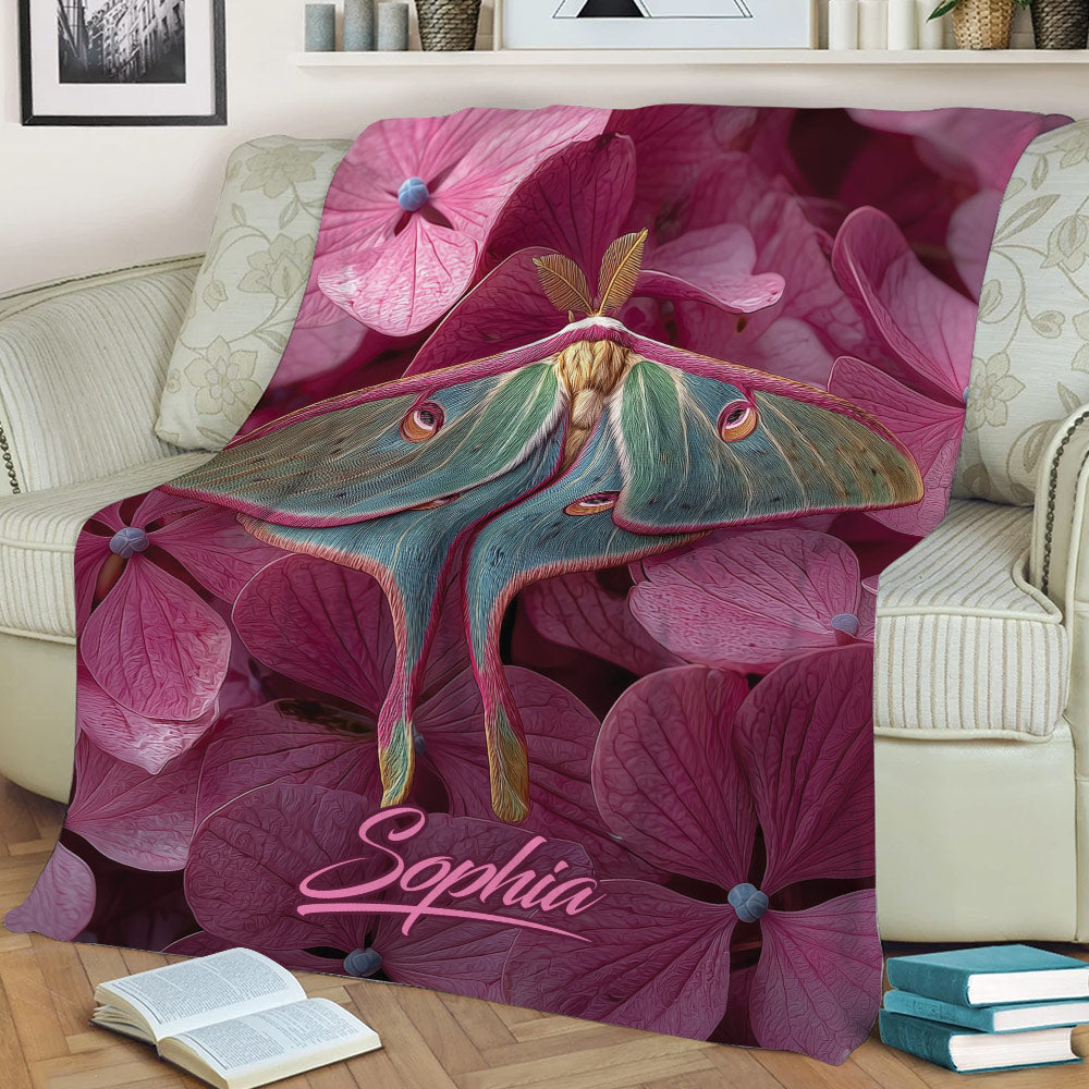 Colorful butterfly and pink flower throw blanket draped across a cozy armchair