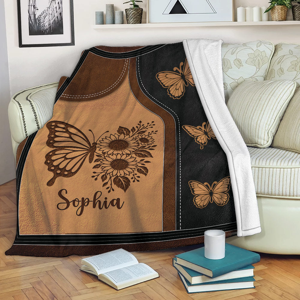 Butterfly and sunflower throw blanket displayed over a sofa in a cozy living room