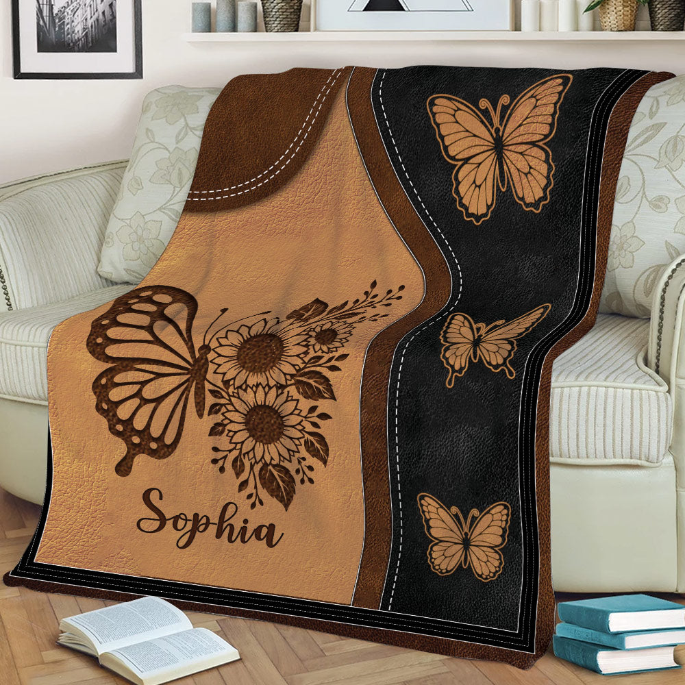 Decorative butterfly throw blanket draped across a sofa with floral artwork