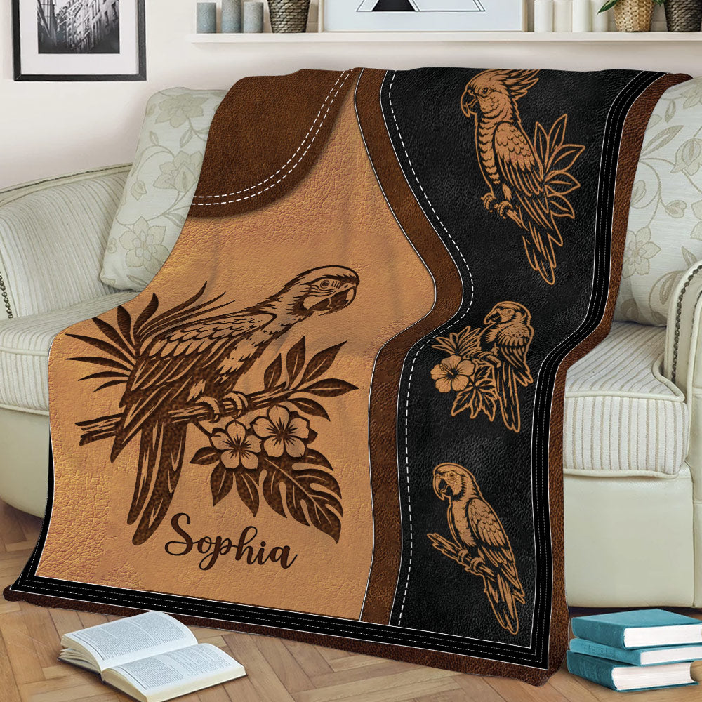 Close view of a parrot throw blanket featuring detailed bird illustrations and tropical flowers