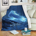 Blue owl throw blanket draped over a sofa with glowing forest artwork
