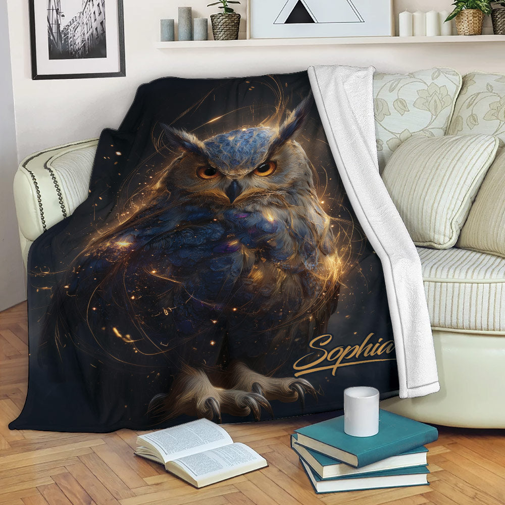 Mystical owl blanket draped over a sofa with glowing artwork, books, and a cozy reading setting