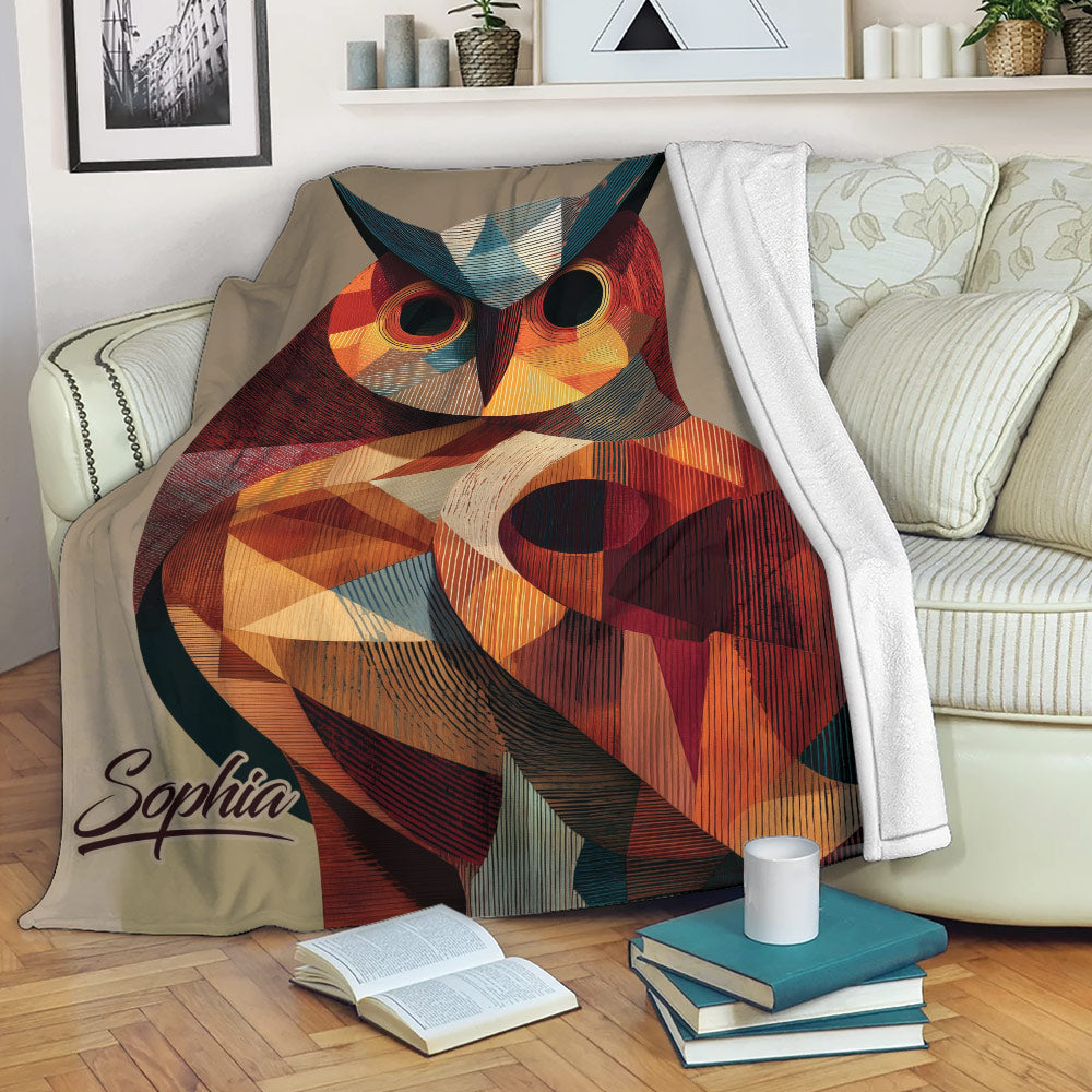 Colorful geometric owl blanket draped over a sofa in a cozy reading space