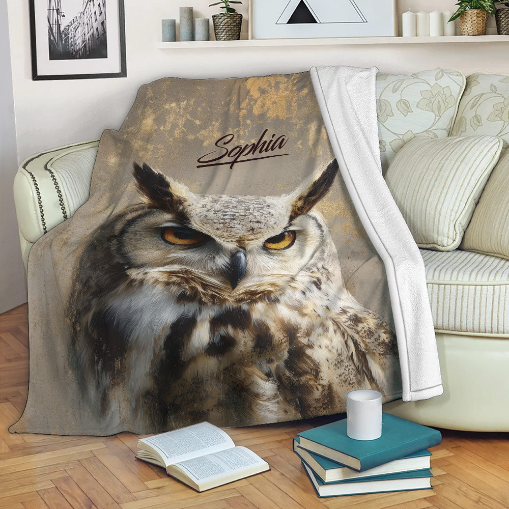Owl throw blanket draped over a sofa with detailed wildlife artwork in a cozy living room