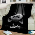 Black bat throw blanket styled on a couch with detailed monochrome bat artwork