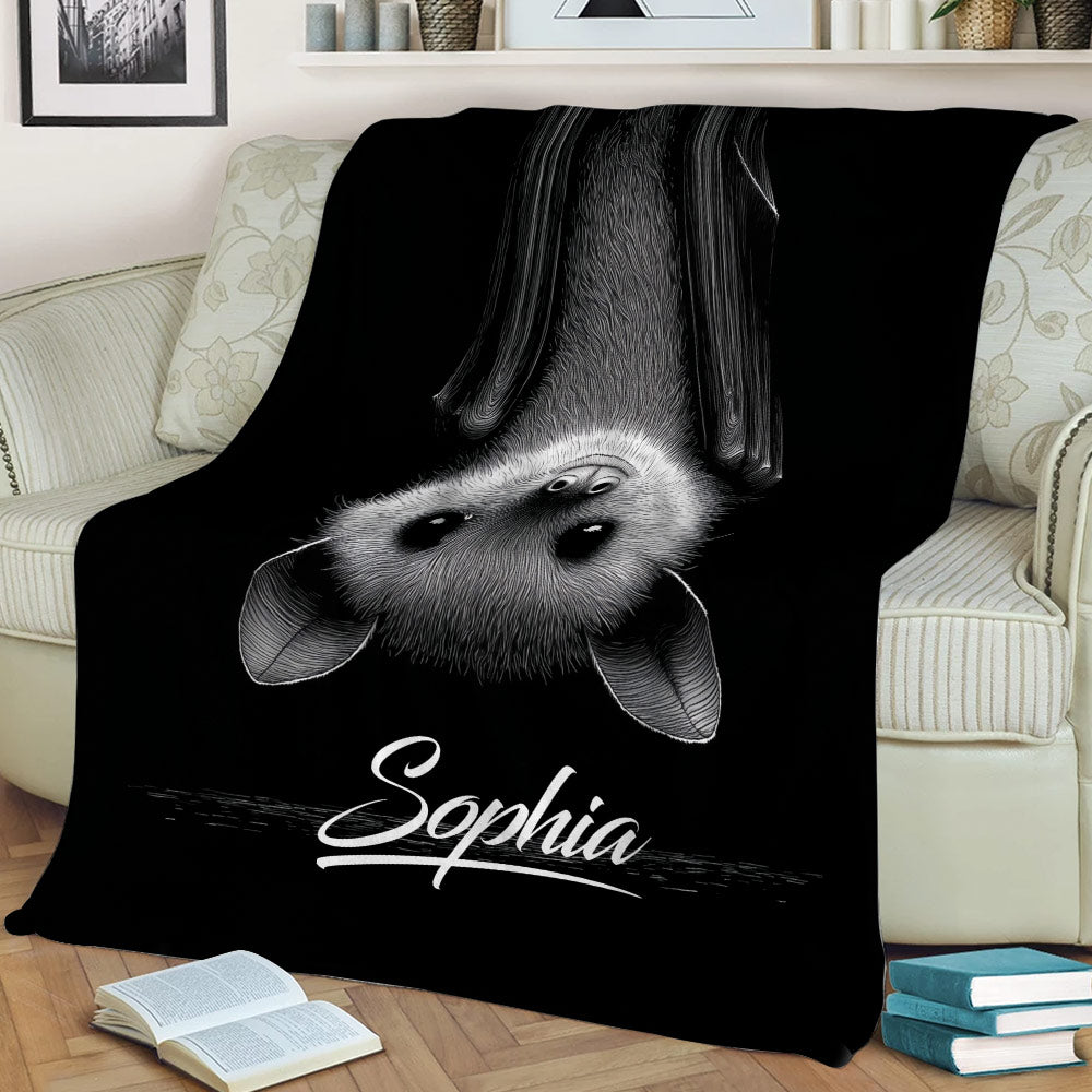 Black bat throw blanket styled on a couch with detailed monochrome bat artwork
