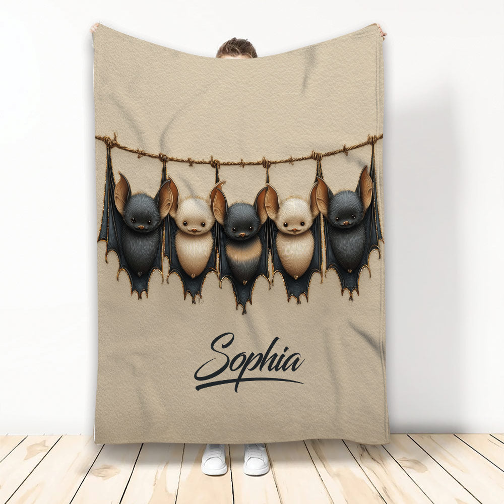 Bat throw blanket featuring five hanging black and tan bats in detailed artwork
