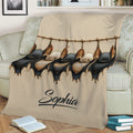 Close lifestyle view of a bat blanket with detailed black and tan bats draped over a sofa