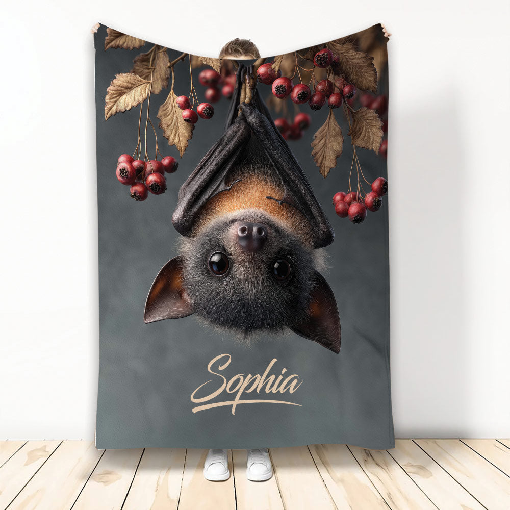Custom bat throw blanket featuring an upside-down bat with autumn leaves and red berries