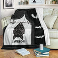 Black and white bat throw blanket draped over a sofa with hanging bat artwork and smaller flying bats