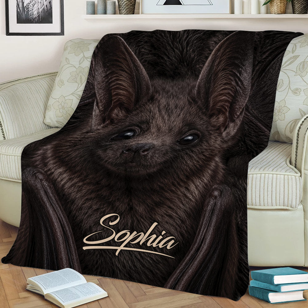 Close view of realistic bat artwork covering a blanket across a sofa