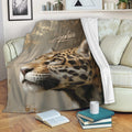Leopard throw blanket draped over a sofa in a cozy living room with books and cushions