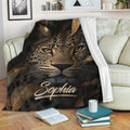 Leopard blanket draped over a sofa with bold wildlife artwork and dark botanical details