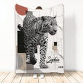 Leopard throw blanket displayed upright with black and white wildlife artwork and modern geometric accents