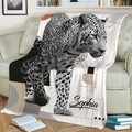 Modern leopard throw blanket draped over a sofa with bold wildlife artwork and geometric details