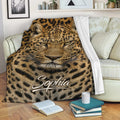 Leopard throw blanket draped over a sofa with realistic wildlife artwork