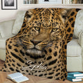 Close-up leopard throw blanket featuring detailed spotted fur and bold golden tones