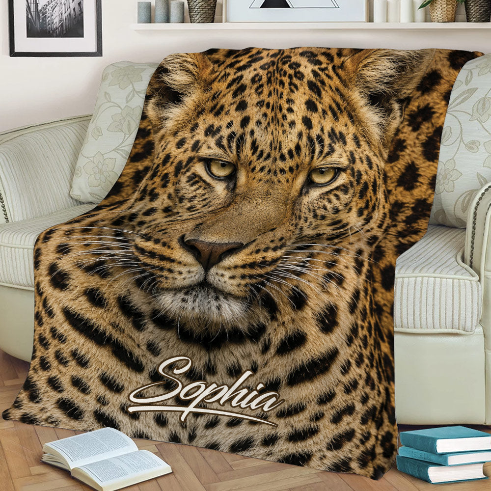 Close-up leopard throw blanket featuring detailed spotted fur and bold golden tones