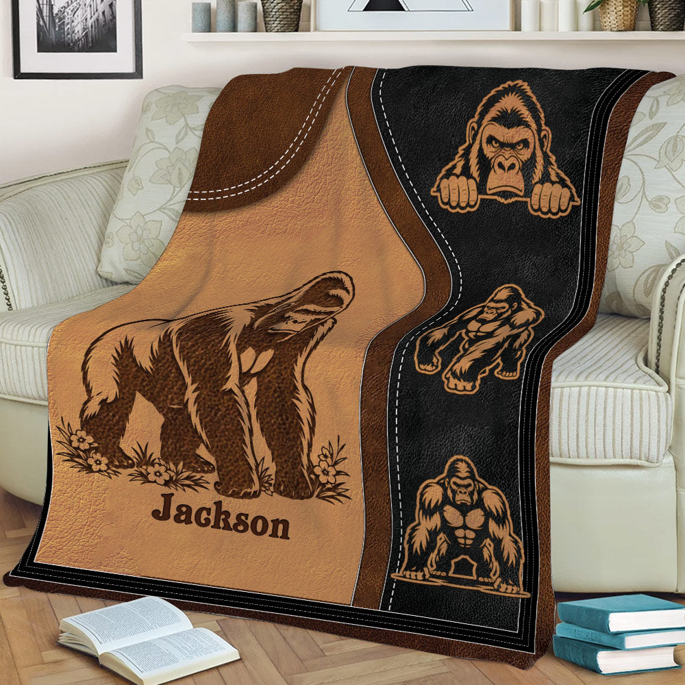 Close view of gorilla throw blanket artwork displayed on a sofa with rugged stitched panel details