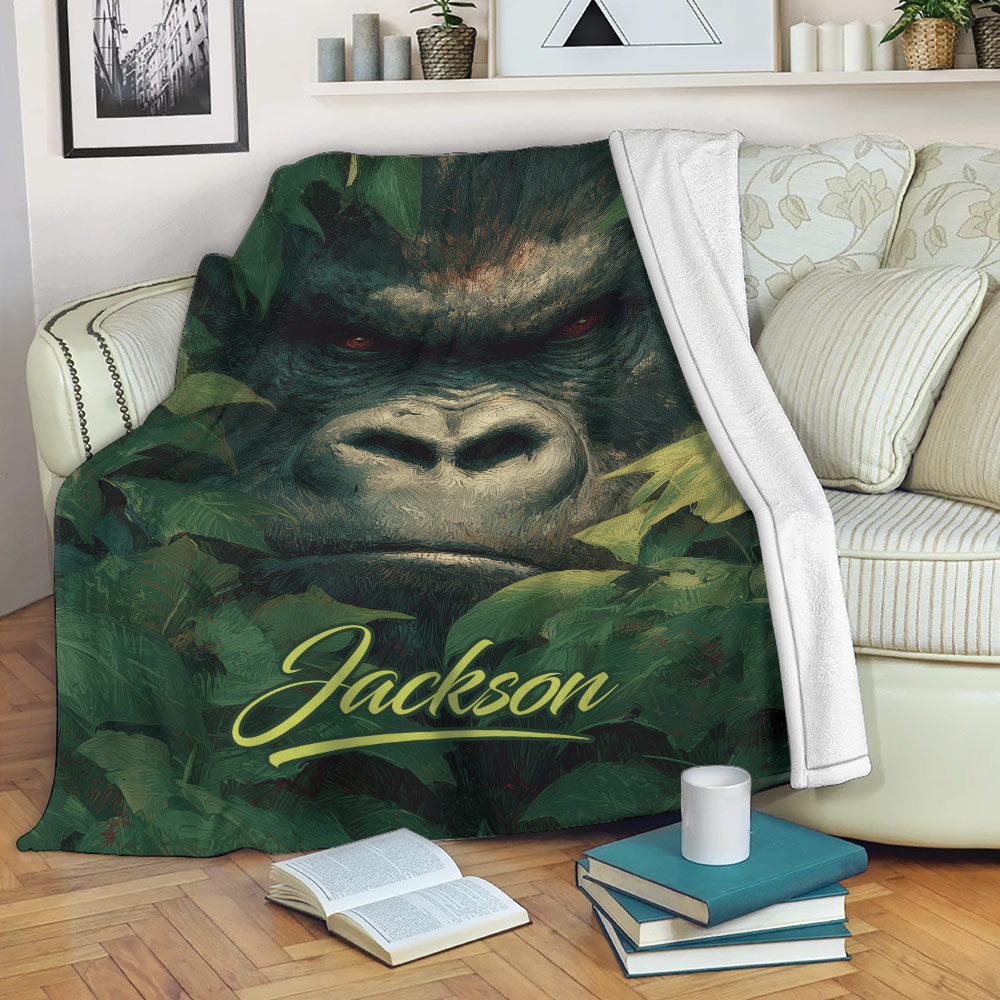 Gorilla blanket displayed on a sofa with bold jungle artwork and leafy surroundings