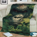 Gorilla throw blanket styled on a couch with expressive wildlife artwork and tropical leaves