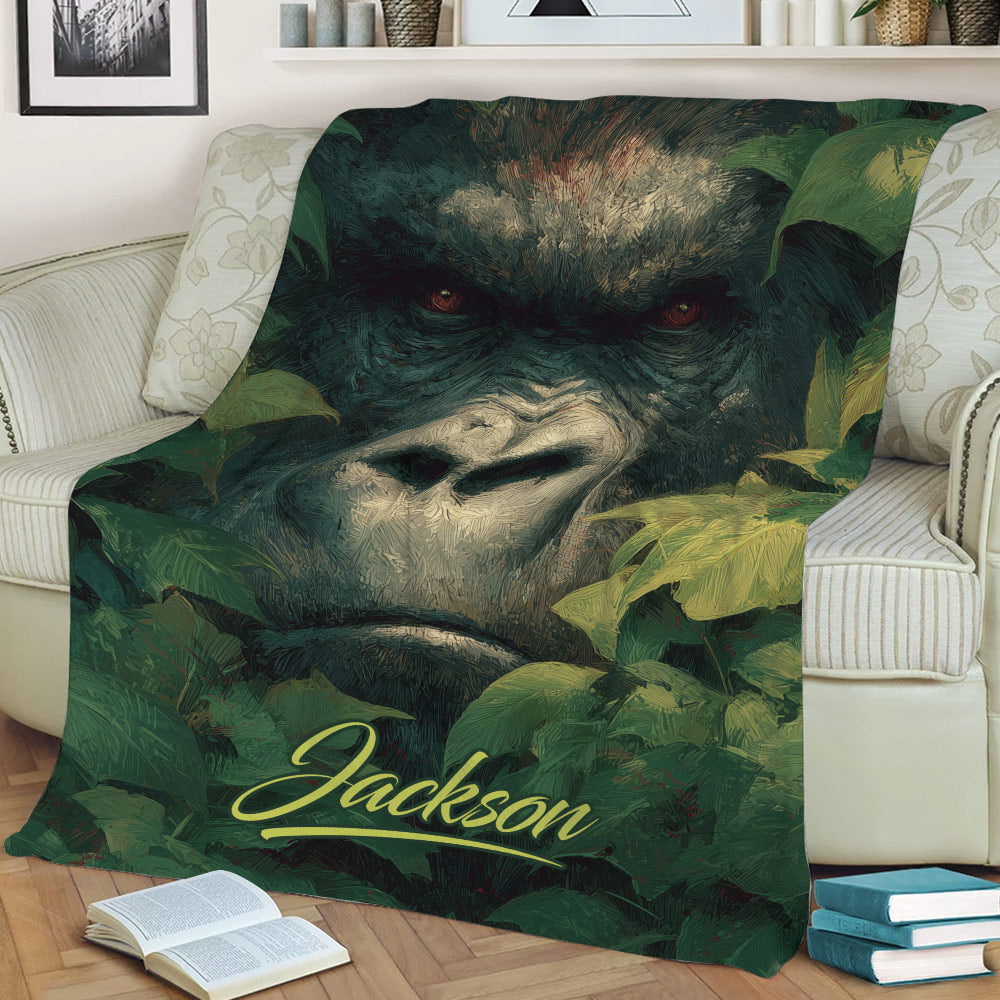 Gorilla throw blanket styled on a couch with expressive wildlife artwork and tropical leaves