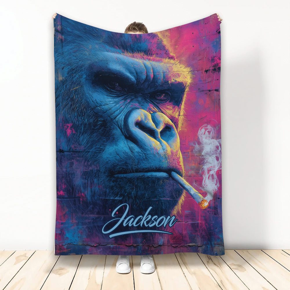 Colorful blue and magenta gorilla artwork on a blanket shown hanging against a white wall