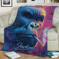 Close lifestyle view of a colorful gorilla blanket draped over a living room couch