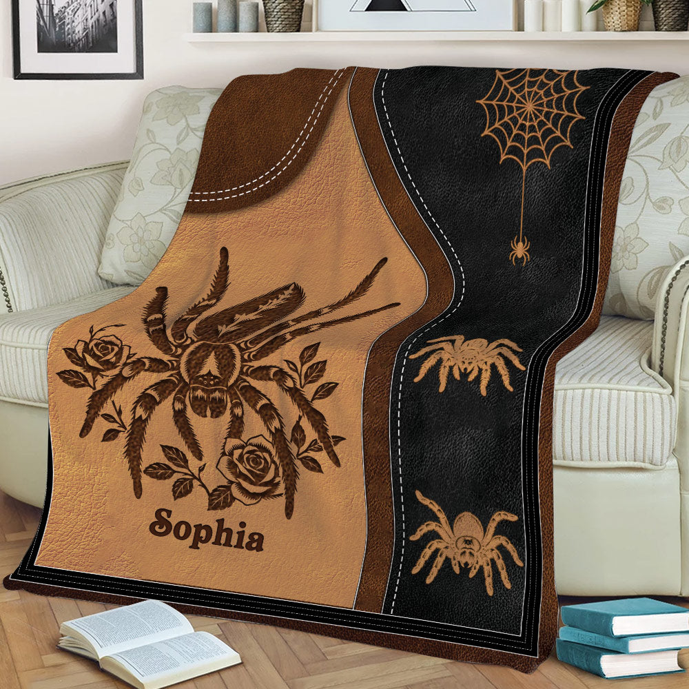 Close view of spider throw blanket design with illustrated spider, roses, web motif, and dark contrast border