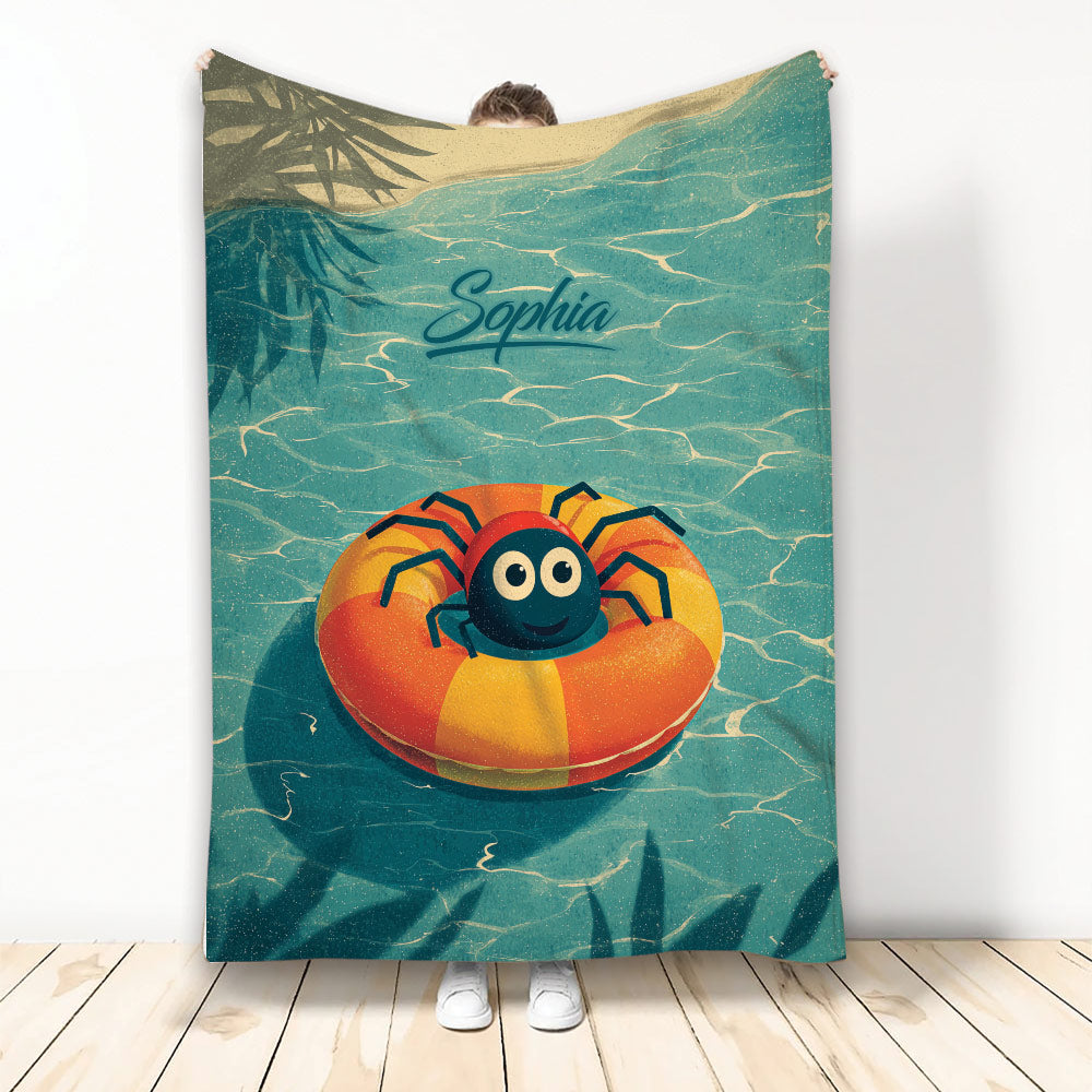 Cute cartoon spider floating on an orange pool ring across a teal water-themed blanket