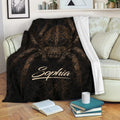 Spider throw blanket draped over a sofa, featuring detailed brown spider artwork and dark web textures