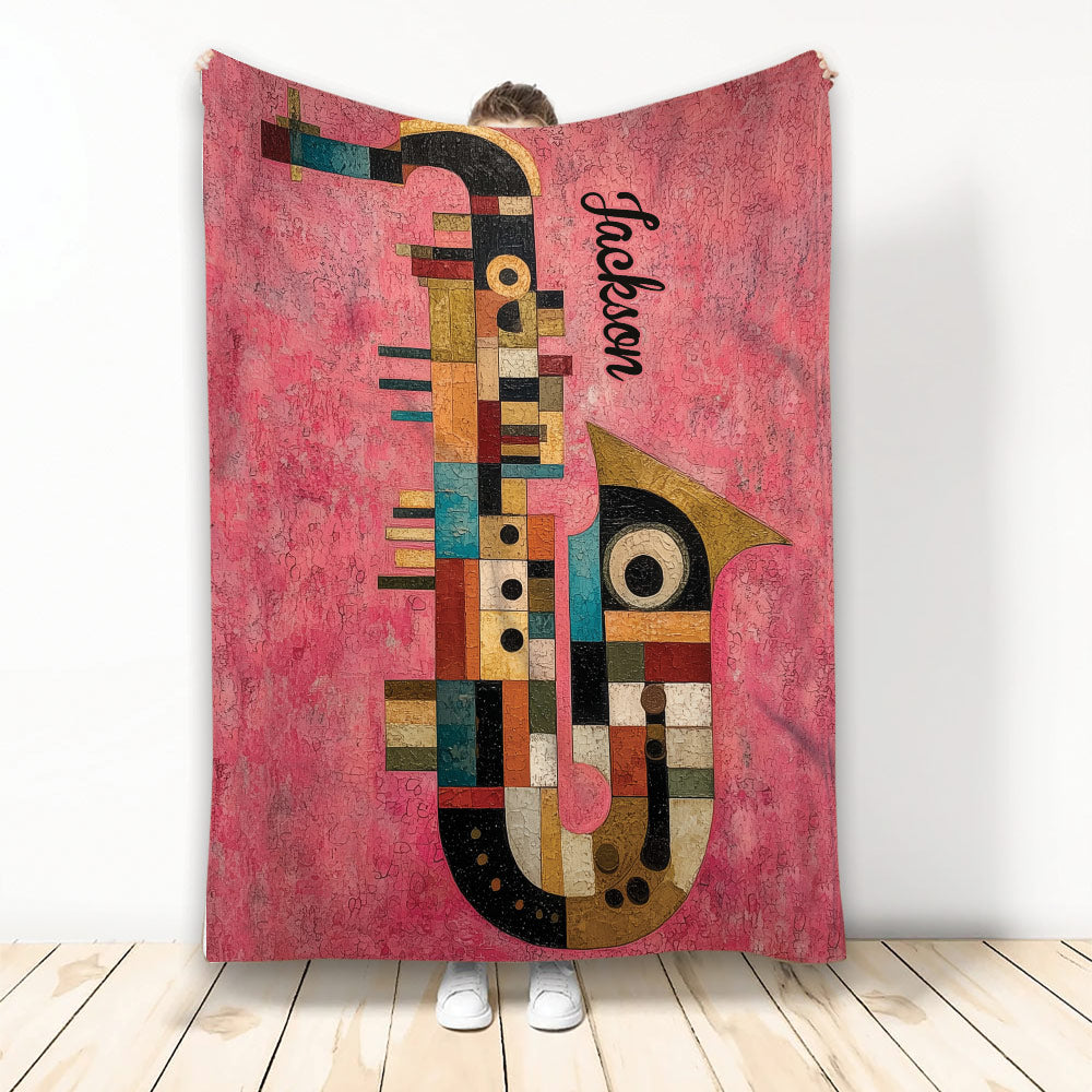 Colorful abstract saxophone artwork on a pink throw blanket displayed against a white background