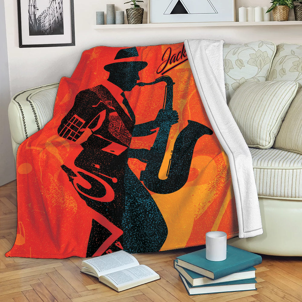Saxophone blanket draped over a sofa, showing bold silhouetted musician artwork in warm jazz colors