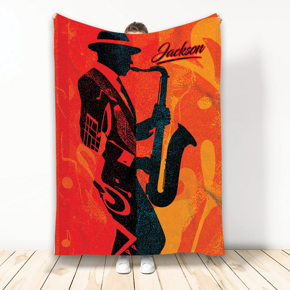 Saxophone throw blanket featuring a silhouetted musician and vivid red, orange, and gold jazz artwork