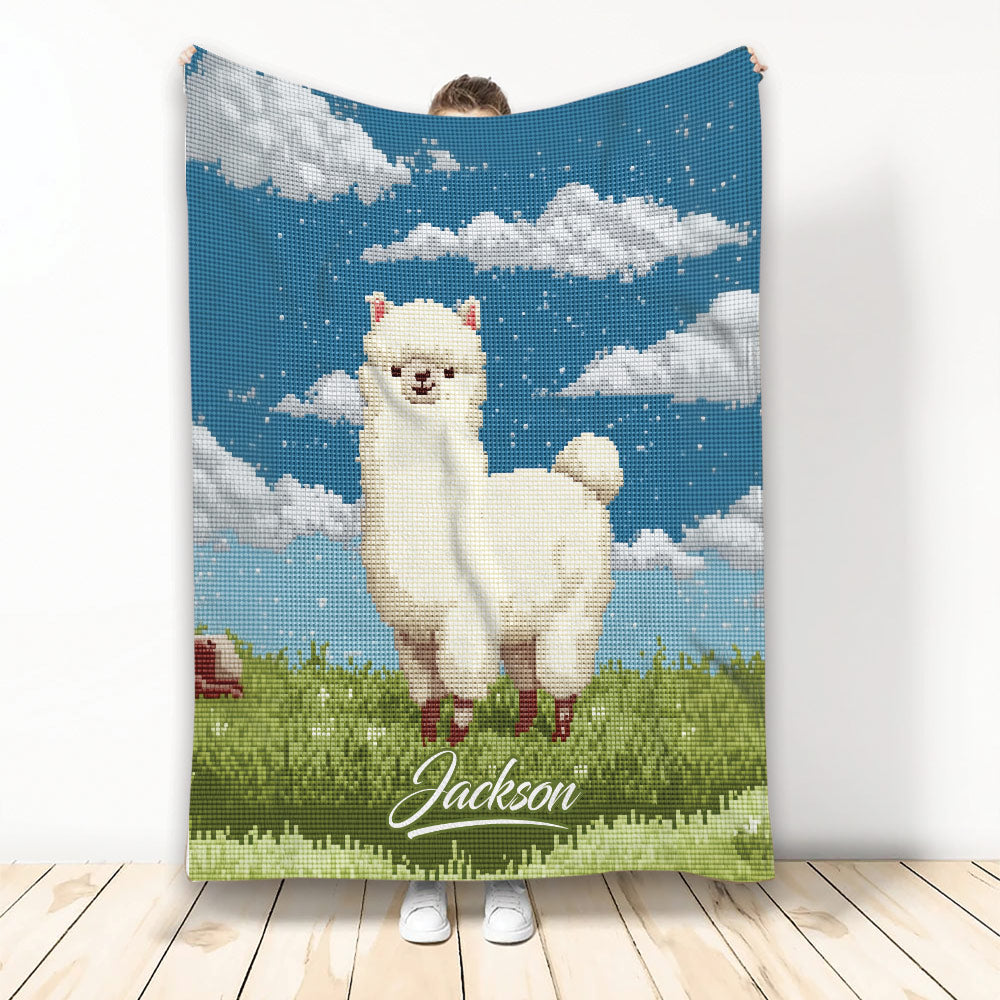 Llama throw blanket featuring pixel-style artwork with a white llama, blue sky, clouds, and green meadow