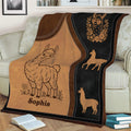 Llama throw blanket displayed on a couch with rustic leather-look artwork and floral details