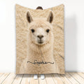 Llama throw blanket displayed upright with a close-up cream llama design in a cozy room