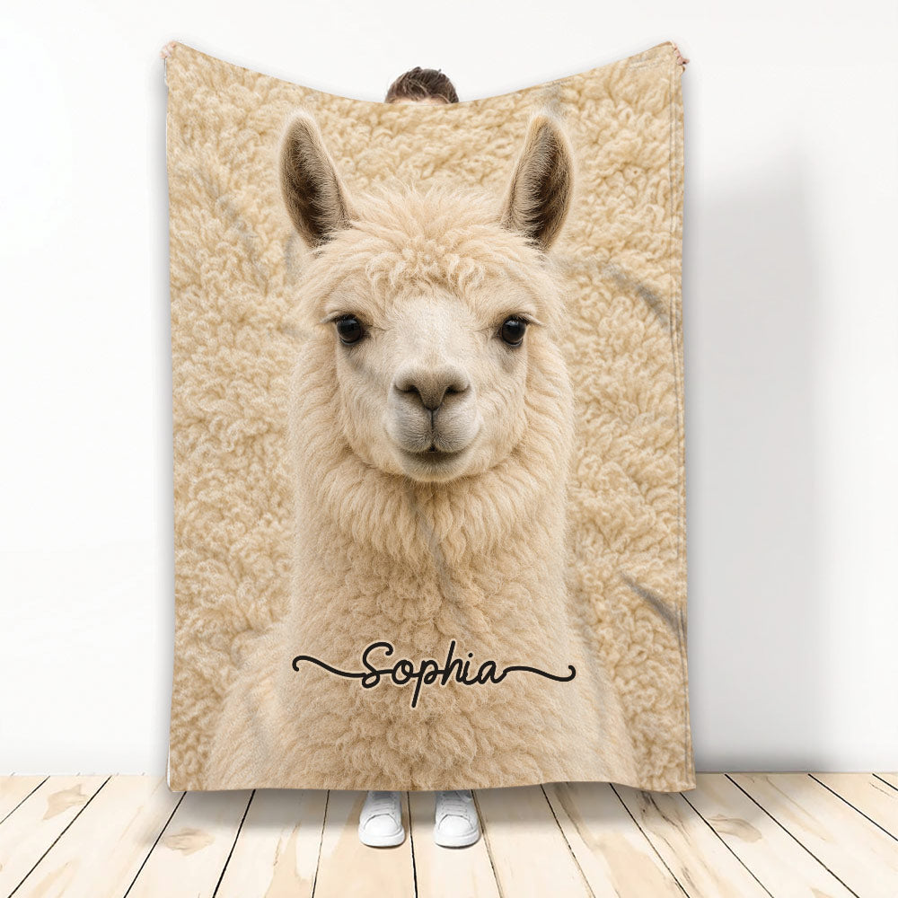 Llama throw blanket displayed upright with a close-up cream llama design in a cozy room